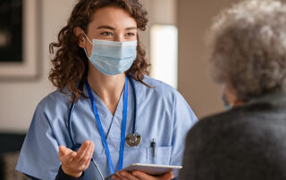 Female nurse practitioner talking to an older female patient